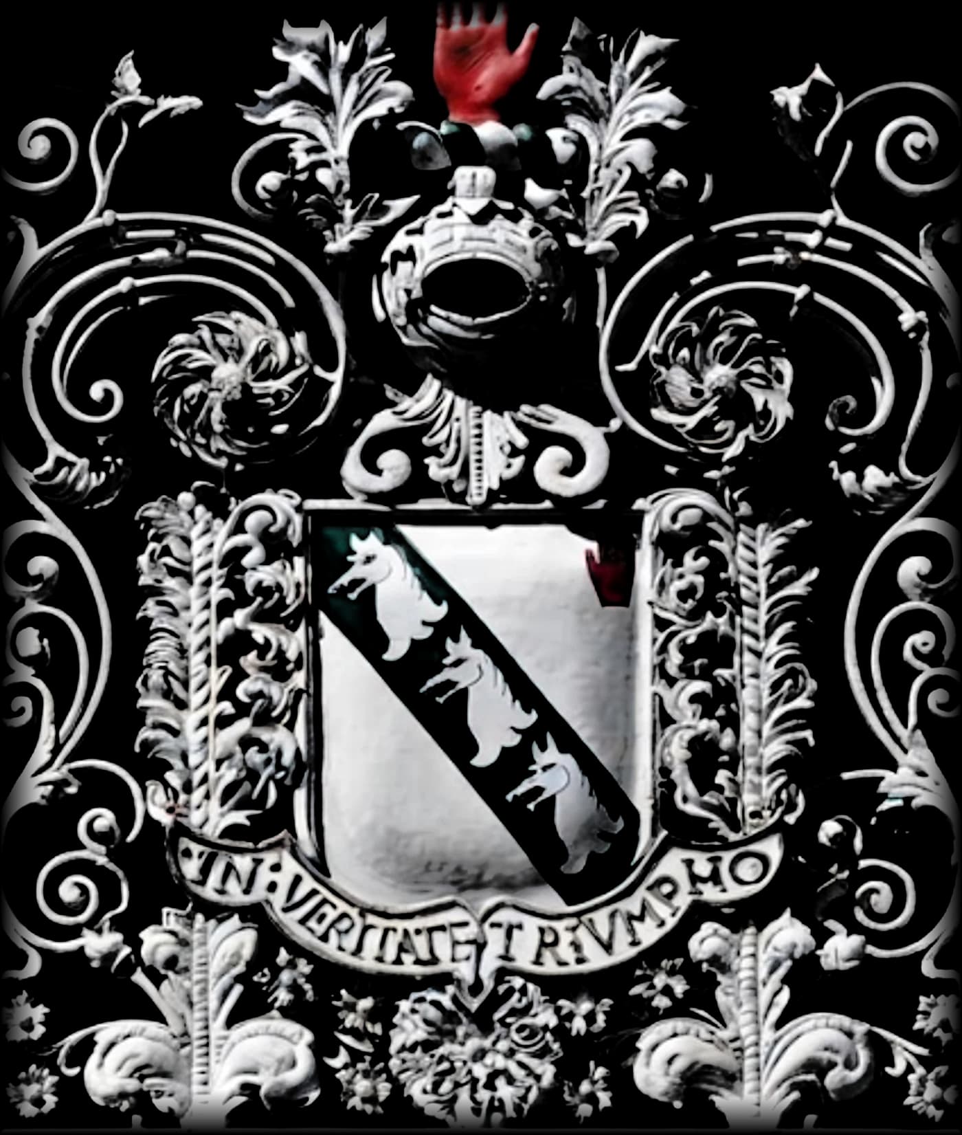 The Middleton family crest in wrought iron: a shield with three wolves' heads on a green bend, surmounted by a helm and a red hand, above the motto In Veritate Triumpho